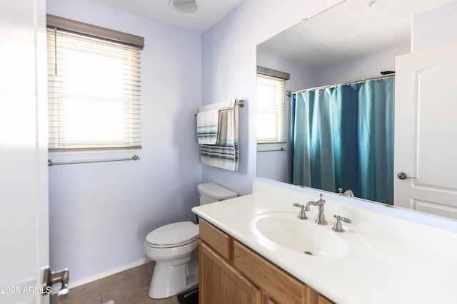 bathroom featuring vanity, tile patterned floors, and toilet