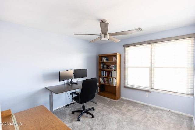 carpeted office space with ceiling fan