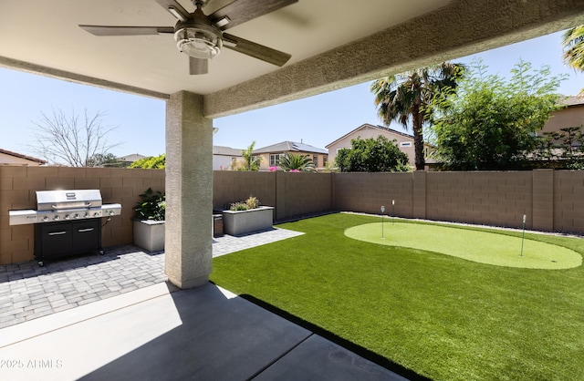 view of yard featuring ceiling fan and a patio