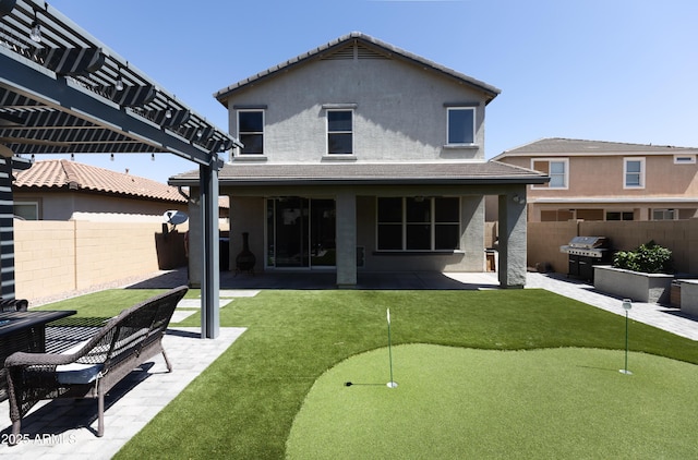 rear view of house featuring a pergola and a patio area