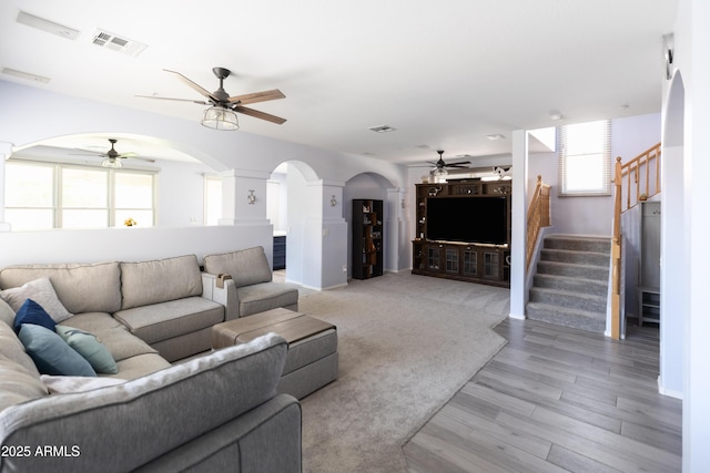 living room with hardwood / wood-style flooring and ceiling fan