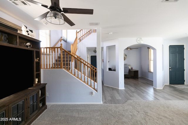 carpeted living room featuring ceiling fan