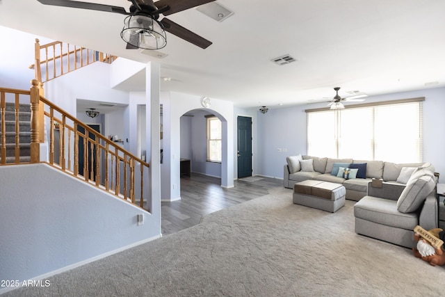 carpeted living room with ceiling fan