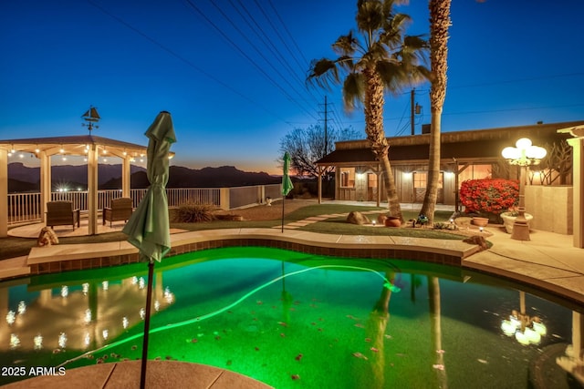 pool at dusk featuring a patio area