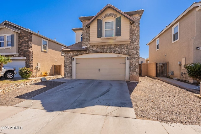 18123 W Lundberg St, Surprise, AZ 85388 - view of front facade featuring stone siding, a garage, and concrete driveway