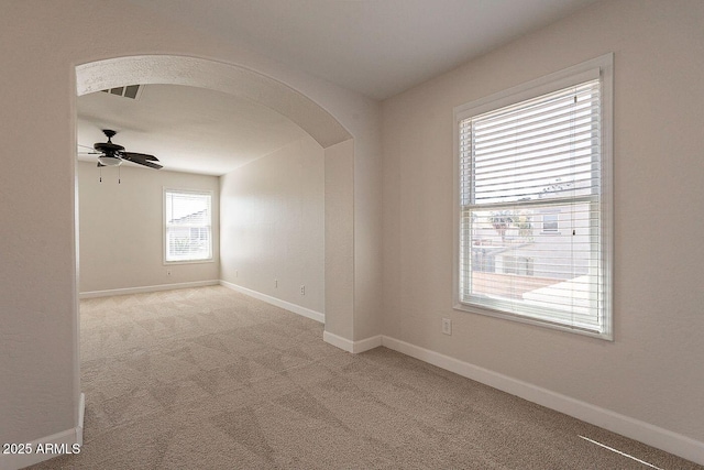 18123 W Lundberg St, Surprise, AZ 85388 - carpeted empty room with arched walkways, ceiling fan, and baseboards