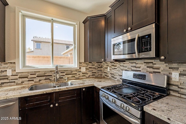 18123 W Lundberg St, Surprise, AZ 85388 - kitchen with appliances with stainless steel finishes, a sink, plenty of natural light, and decorative backsplash