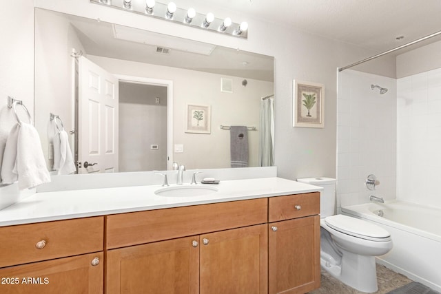 full bathroom with vanity, tiled shower / bath, and toilet