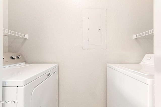 washroom featuring electric panel and washing machine and clothes dryer