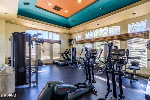 gym featuring a tray ceiling