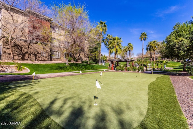 surrounding community featuring a pergola and a lawn