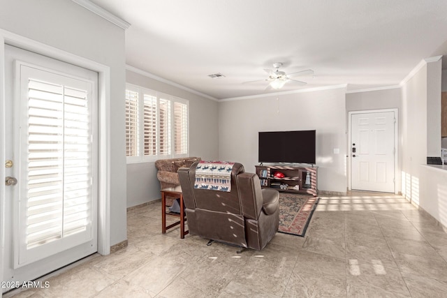 living room with crown molding, ceiling fan, and a healthy amount of sunlight