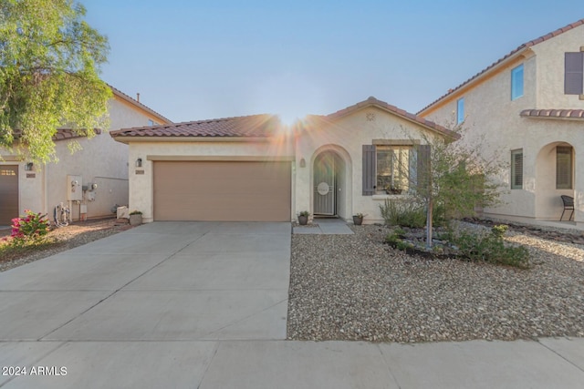 mediterranean / spanish-style home with a garage