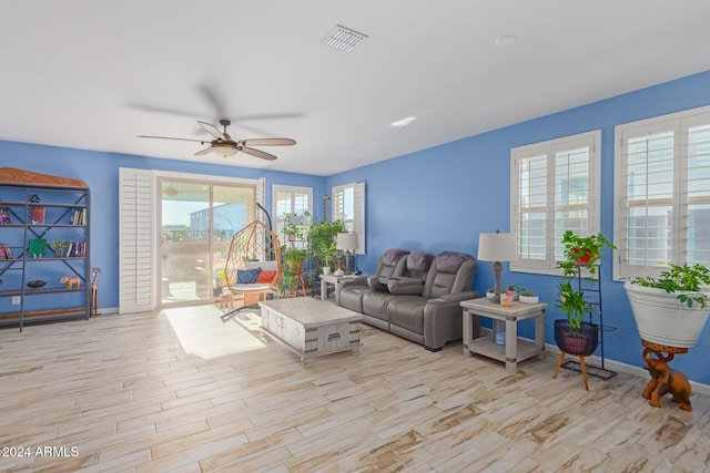 living room featuring ceiling fan and light wood-type flooring