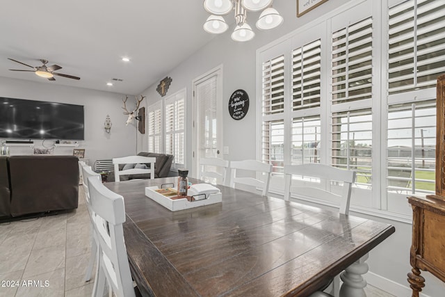 tiled dining area featuring ceiling fan