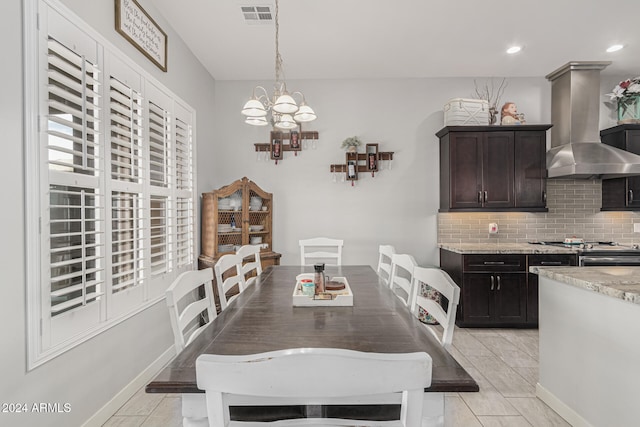 dining area featuring light tile patterned floors and a chandelier