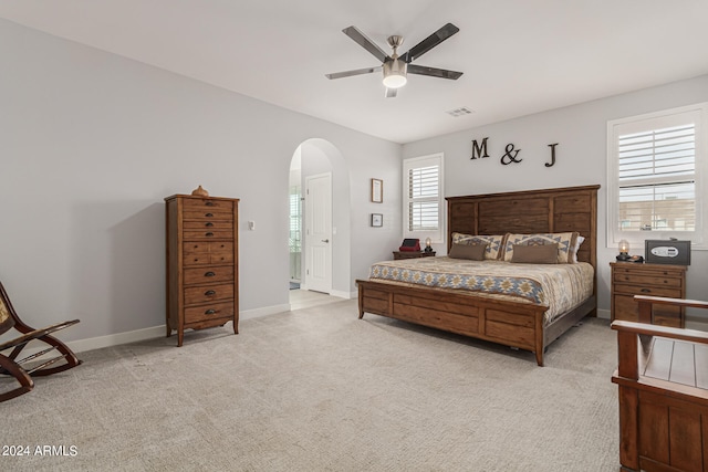 bedroom with ceiling fan and light carpet