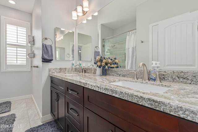 bathroom with tile patterned flooring, vanity, and curtained shower