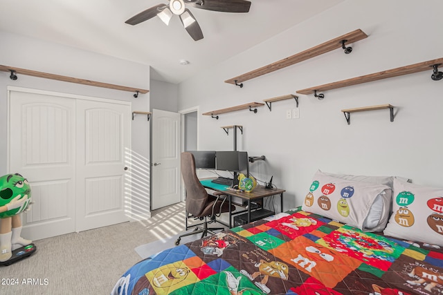 bedroom with ceiling fan, light colored carpet, and a closet