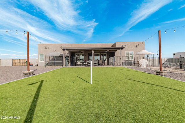 back of property featuring a lawn and a patio area