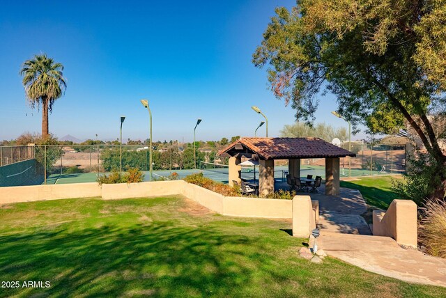 view of home's community with a gazebo, a lawn, and tennis court