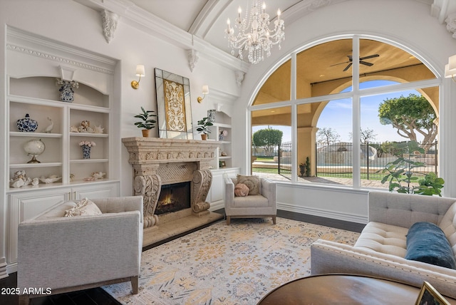 living room with built in shelves and a chandelier