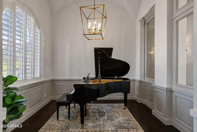 miscellaneous room with dark wood-type flooring and a chandelier