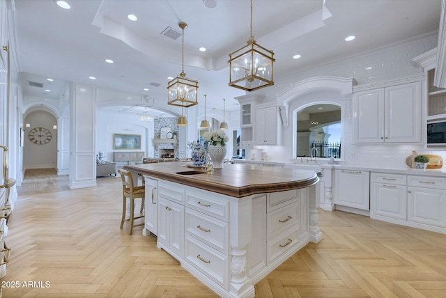 kitchen featuring white cabinetry, a center island, and a tray ceiling