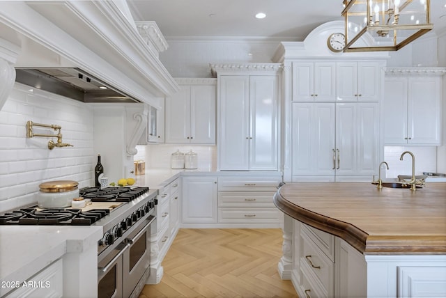 kitchen featuring premium range hood, white cabinetry, hanging light fixtures, double oven range, and light parquet flooring