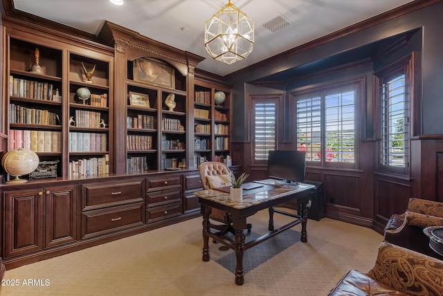 carpeted office space featuring crown molding and a notable chandelier