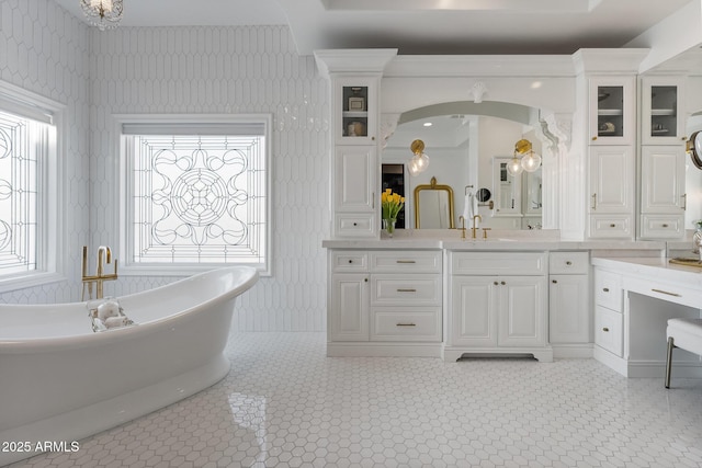 bathroom with ceiling fan, vanity, and a bath