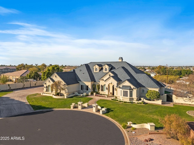 french country home featuring a front yard