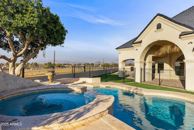 view of swimming pool featuring an in ground hot tub