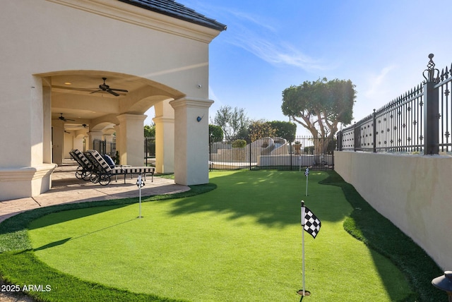 view of yard with a patio and ceiling fan