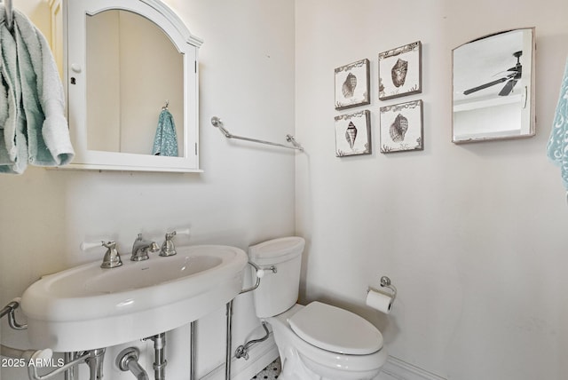 bathroom featuring sink, ceiling fan, and toilet