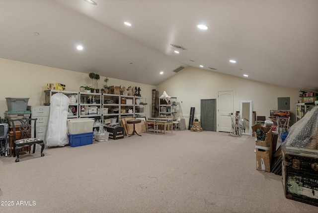 misc room featuring light colored carpet, electric panel, and vaulted ceiling