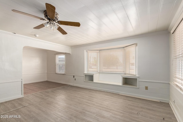813 N Gilbert Ave, Casa Grande, AZ 85122 - empty room with arched walkways, ceiling fan, ornamental molding, and wood finished floors