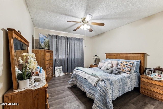 bedroom with ceiling fan, dark hardwood / wood-style flooring, and a textured ceiling