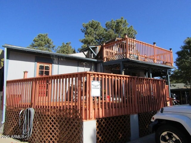 back of house featuring a wooden deck