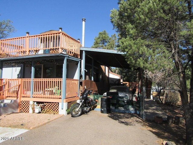 view of front of home featuring aphalt driveway and an attached carport