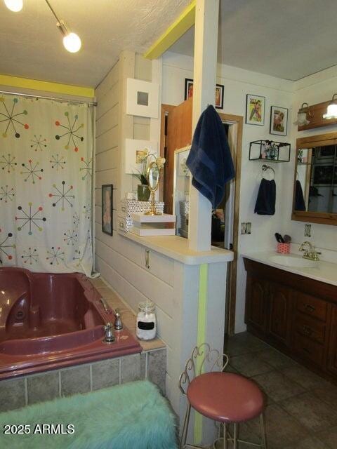 bathroom with tiled bath, curtained shower, vanity, and tile patterned flooring