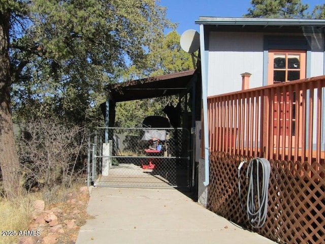 exterior space featuring a carport and a gate