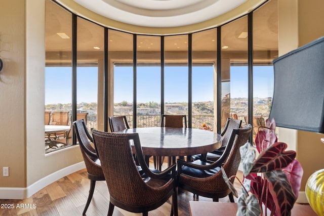 dining room featuring hardwood / wood-style flooring and expansive windows