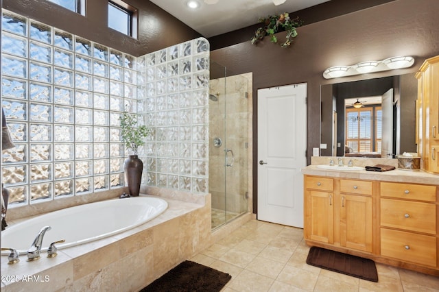 bathroom featuring vanity, plus walk in shower, and tile patterned flooring