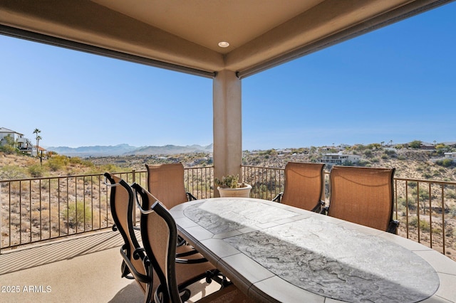 view of patio featuring a balcony and a mountain view