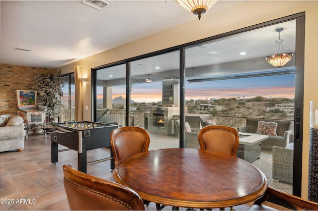 dining room with brick wall and a wealth of natural light