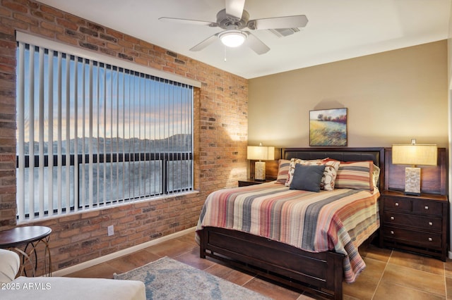 tiled bedroom featuring brick wall and ceiling fan