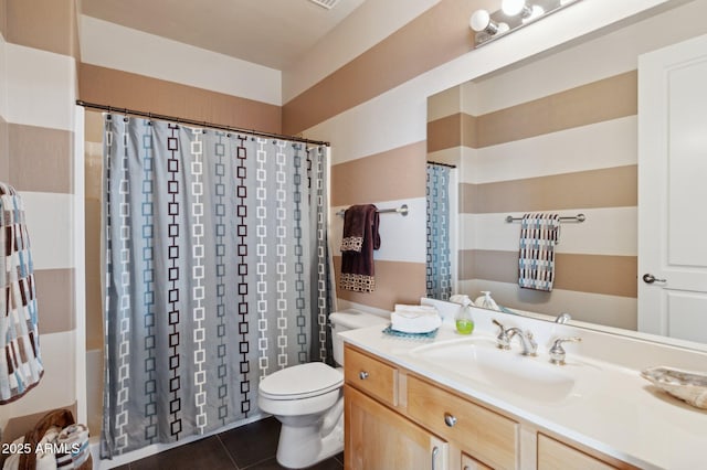 bathroom with vanity, tile patterned flooring, and toilet