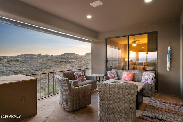 balcony at dusk with a mountain view and an outdoor hangout area