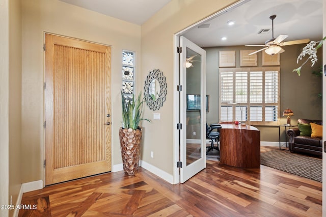 foyer entrance with ceiling fan